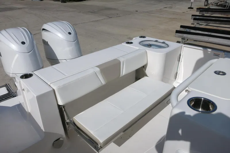 Slide: The Image of 2025 Robalo R250 Center Console boat with dual engines and white seating. - 25