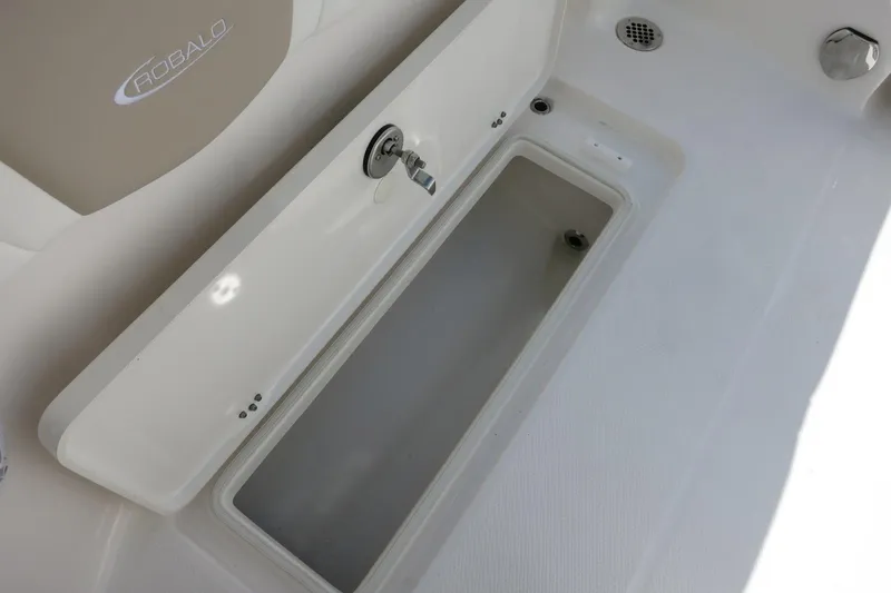 Slide: The Image of 2025 Robalo R250 Center Console boat storage compartment with open lid. - 31