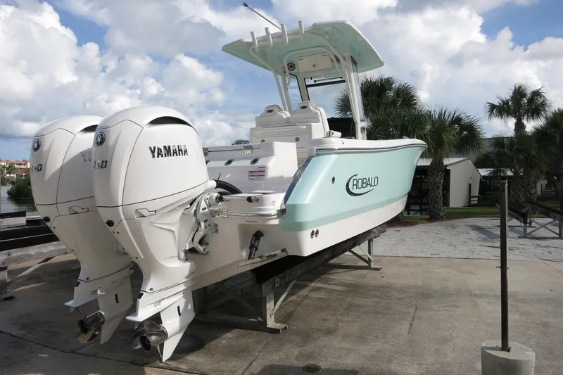 Slide: The Image of 2025 Robalo R250 Center Console boat with twin Yamaha engines on display. - 8