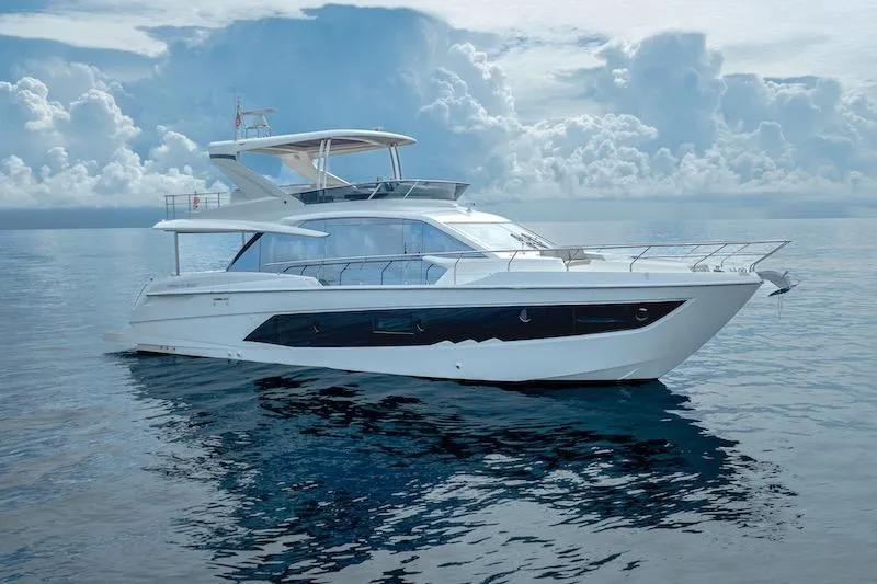 Slide: The Image of 2023 Absolute 62 Fly yacht on calm ocean under cloudy sky. - 2