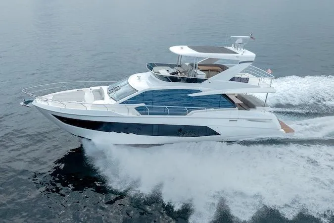 Slide: The Image of 2023 Absolute 62 Fly yacht cruising on open water, showcasing sleek design and luxury features. - 3