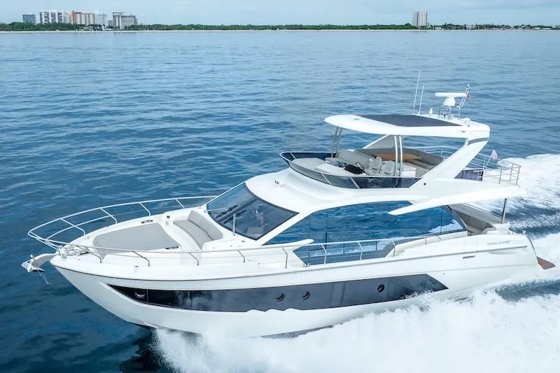 Slide: The Image of 2023 Absolute 62 Fly yacht cruising on open water, showcasing sleek design and luxury features. - 4