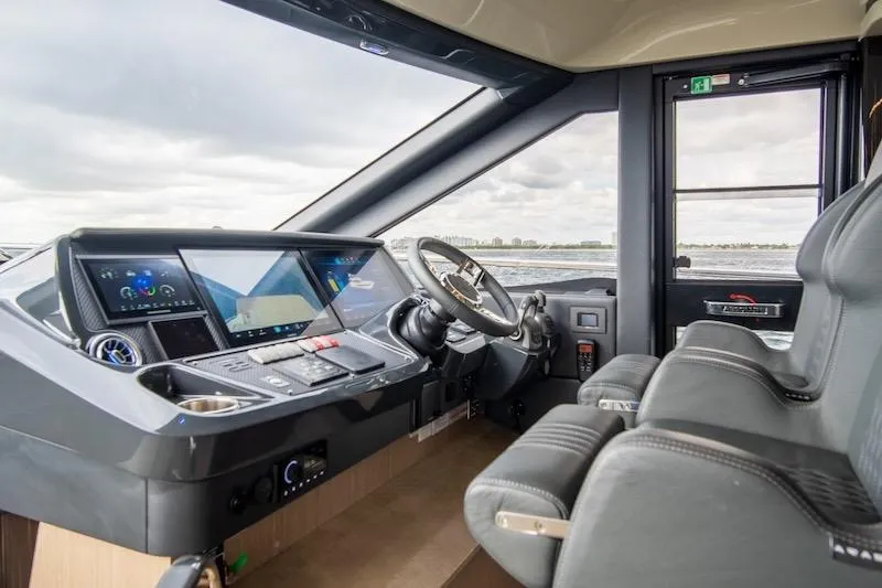 Slide: The Image of 2023 Absolute 62 Fly yacht cockpit with modern navigation controls and luxurious seating. - 53