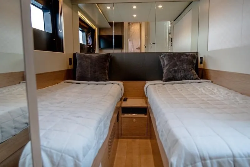 Slide: The Image of Luxurious twin cabin interior of 2023 Absolute 62 Fly yacht, featuring modern design and cozy bedding. - 65