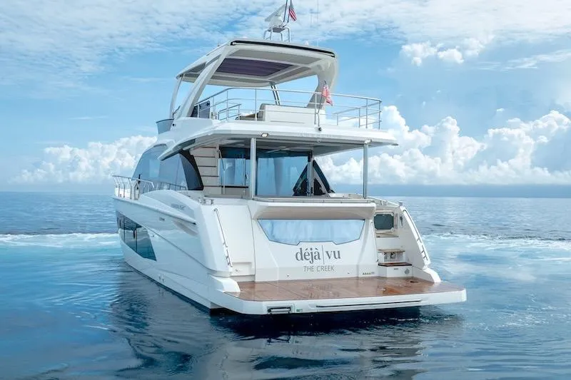 Slide: The Image of Luxury Absolute 62 Fly yacht cruising on calm ocean waters, 2023 model. - 8