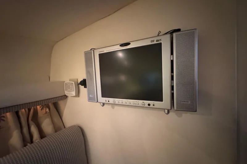 Slide: The Image of Wall-mounted TV with speakers in 2004 Four Winns 268 Vista cabin interior. - 12