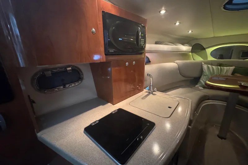 Slide: The Image of 2004 Four Winns 268 Vista cabin interior with kitchenette and seating area. - 14