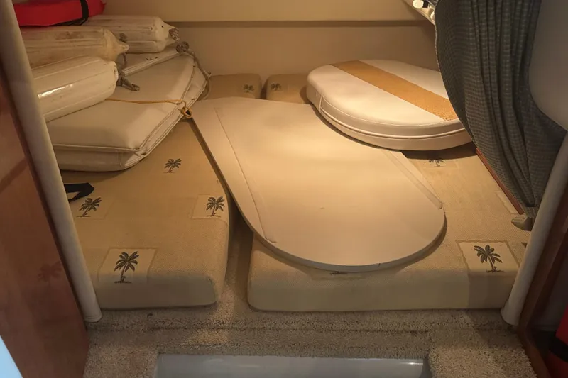 Slide: The Image of Interior cabin of 2004 Four Winns 268 Vista boat with cushions and table. - 17