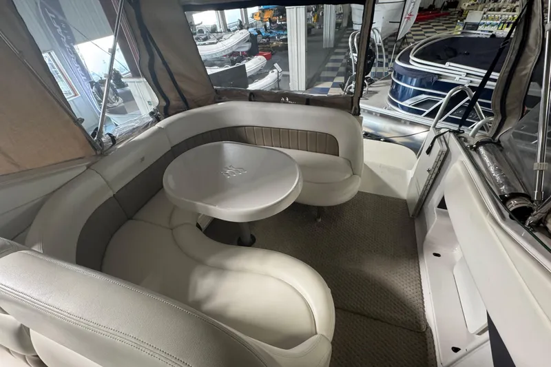 Slide: The Image of 2004 Four Winns 268 Vista boat interior with cushioned seating and table. - 2