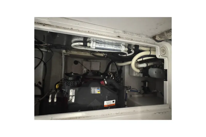 Slide: The Image of Engine compartment of 2004 Four Winns 268 Vista boat, showing mechanical components and wiring. - 25