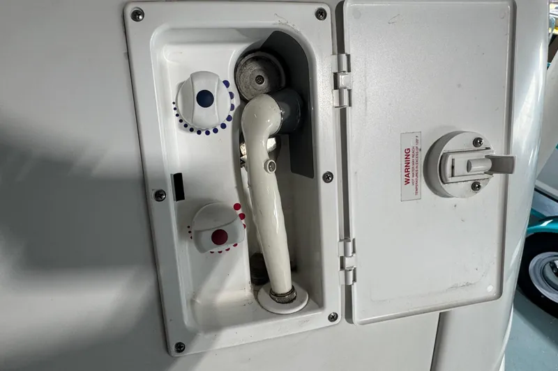 Slide: The Image of 2004 Four Winns 268 Vista boat shower controls with temperature dials and hose. - 27