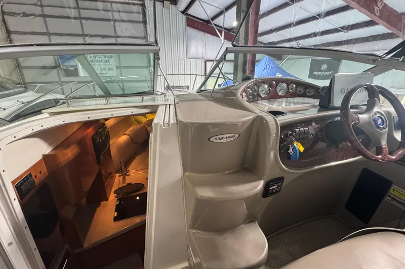 Slide: The Image of 2004 Four Winns 268 Vista boat interior with cockpit and cabin view. - 7