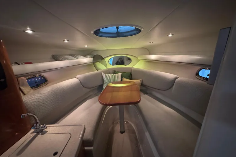 Slide: The Image of 2004 Four Winns 268 Vista cabin interior with cozy seating and table. - 9