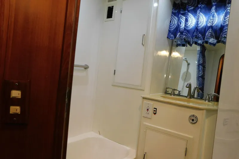 Slide: The Image of Bathroom interior of 1995 Jefferson 52 Riviana Cockpit MY yacht with sink and blue curtains. - 18