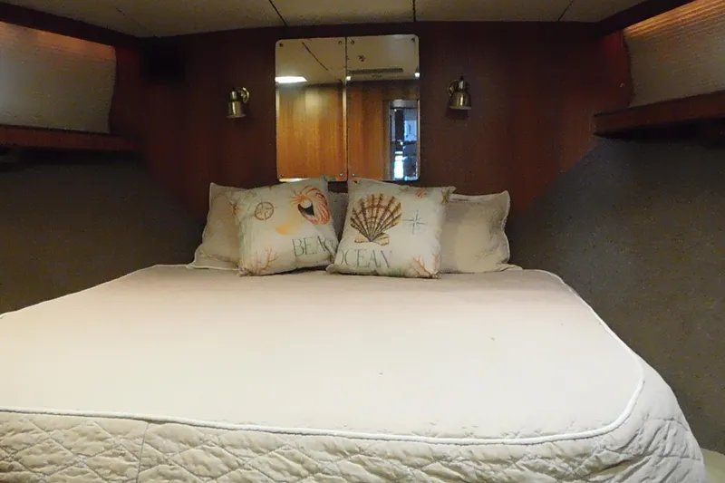 Slide: The Image of Cozy bedroom in 1995 Jefferson 52 Riviana Cockpit MY yacht with nautical-themed pillows. - 23