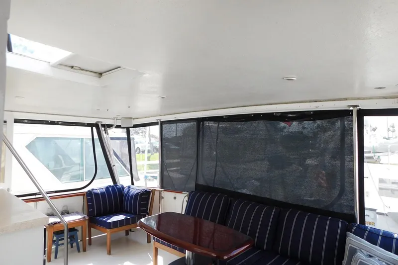 Slide: The Image of Interior of 1995 Jefferson 52 Riviana Cockpit MY with seating and table. - 34