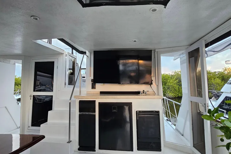 Slide: The Image of Interior of 1995 Jefferson 52 Riviana Cockpit MY with TV, stairs, and outdoor view. - 35
