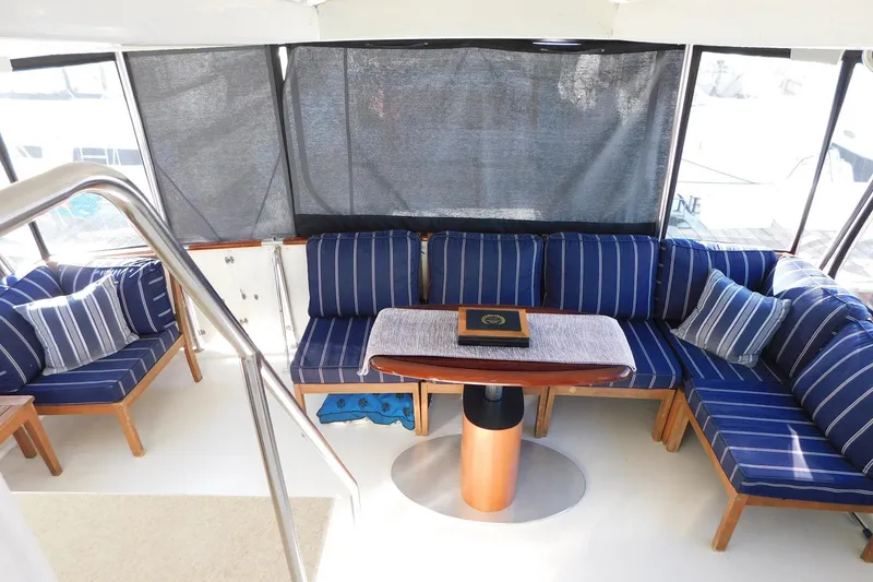 Slide: The Image of 1995 Jefferson 52 Riviana Cockpit MY interior with blue striped seating and table. - 40
