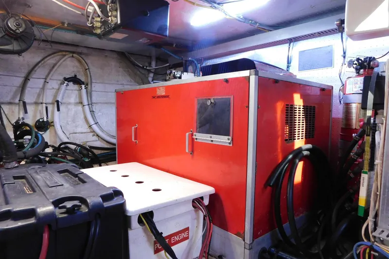 Slide: The Image of Engine room of 1995 Jefferson 52 Riviana Cockpit MY with red machinery and cables. - 43
