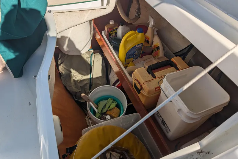 Slide: The Image of Storage compartment on a 2001 Beneteau Oceanis 331 sailboat with cleaning supplies and tools. - 10