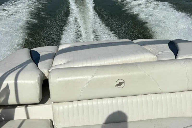 Slide: The Image of 2007 Starcraft 2100 IO RE Limited boat with white seating, cruising on water. - 4