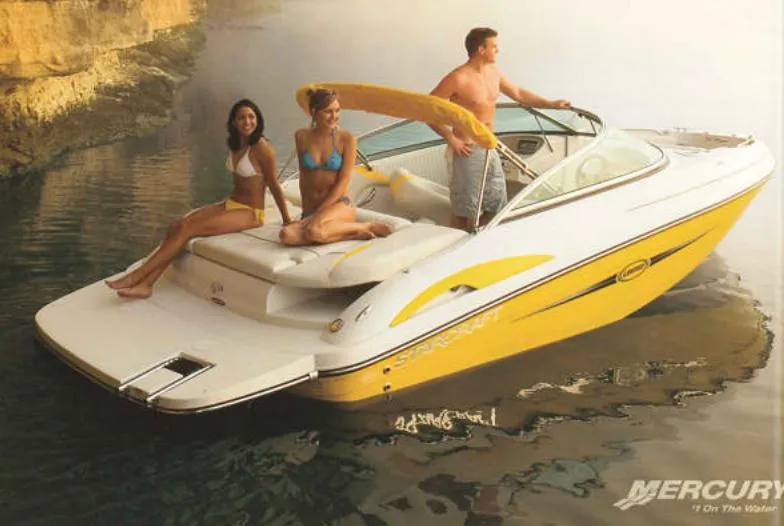 Slide: The Image of 2007 Starcraft 2100 IO RE Limited boat with people enjoying a sunny day on the water. - 8