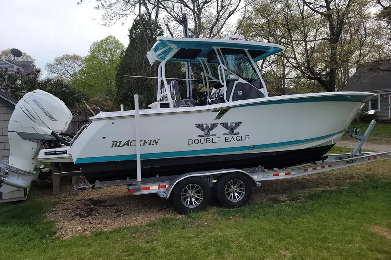 Slide: The Image of 2018 Blackfin 272 CC boat on trailer, featuring "Double Eagle" branding and Mercury outboard engine. - 1