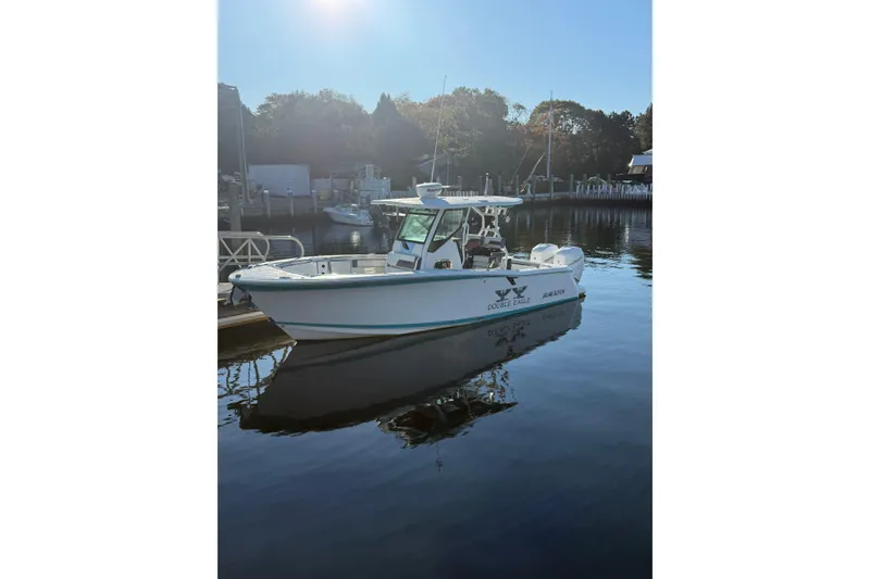 Slide: The Image of 2018 Blackfin 272 CC boat docked in calm waters under clear sky. - 18