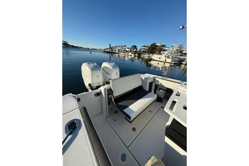 Slide: The Image of 2018 Blackfin 272 CC boat with dual Mercury engines docked in a marina. - 24