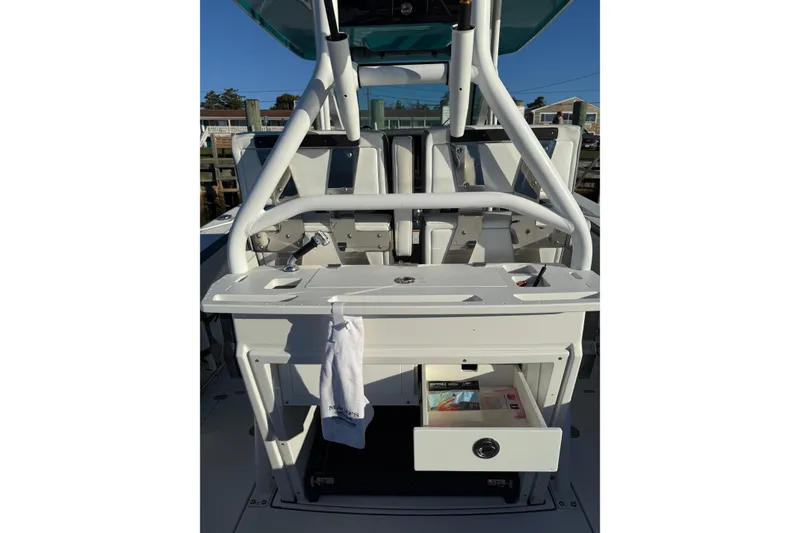 Slide: The Image of 2018 Blackfin 272 CC boat console with open storage drawer and towel hanging. - 26