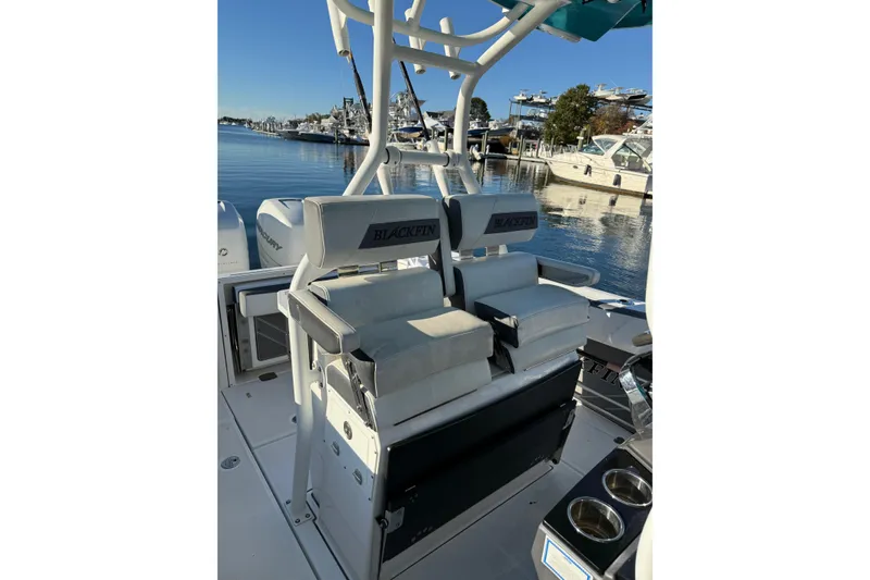 Slide: The Image of 2018 Blackfin 272 CC boat interior with seating, docked at marina. - 28
