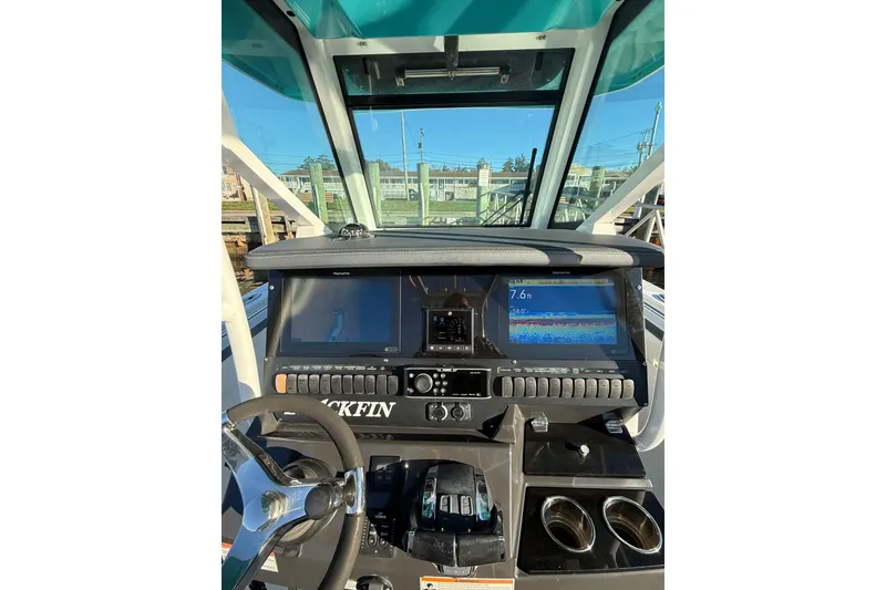 Slide: The Image of 2018 Blackfin 272 CC boat dashboard with navigation screens and controls. - 32