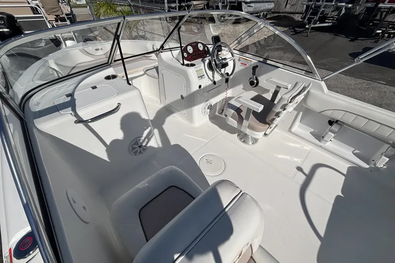 Slide: The Image of 2013 Sea Hunt Escape 188 boat interior with steering wheel and seating. - 10