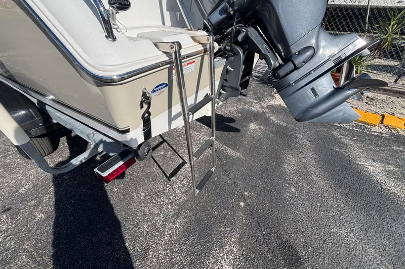 Slide: The Image of 2013 Sea Hunt Escape 188 boat with ladder and outboard motor on trailer. - 11