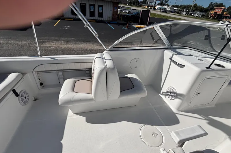 Slide: The Image of 2013 Sea Hunt Escape 188 boat interior with white seating and dashboard. - 13
