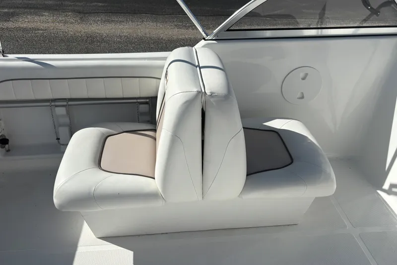 Slide: The Image of 2013 Sea Hunt Escape 188 boat interior with white cushioned seating. - 14