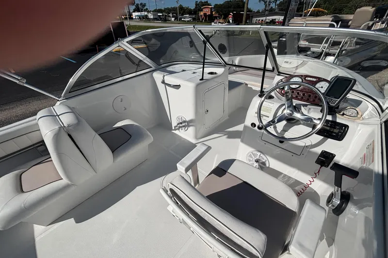 Slide: The Image of 2013 Sea Hunt Escape 188 boat interior with steering wheel and seating. - 15