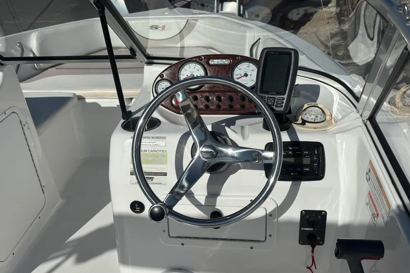 Slide: The Image of 2013 Sea Hunt Escape 188 boat dashboard with steering wheel, gauges, and navigation equipment. - 16