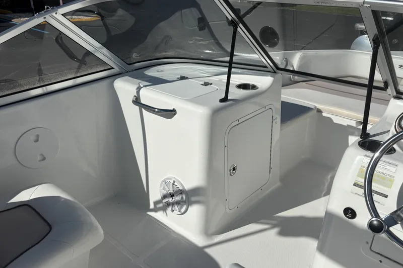 Slide: The Image of 2013 Sea Hunt Escape 188 boat interior with console and seating area. - 17