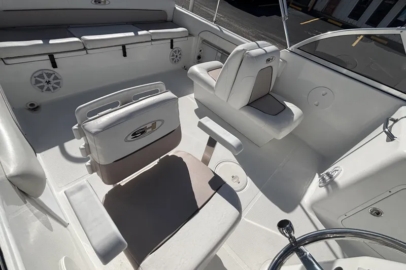 Slide: The Image of 2013 Sea Hunt Escape 188 boat interior with seating and steering wheel. - 18