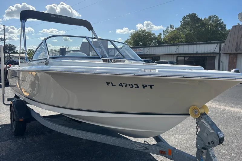 Slide: The Image of 2013 Sea Hunt Escape 188 boat on trailer, sunny day, outdoor setting. - 2