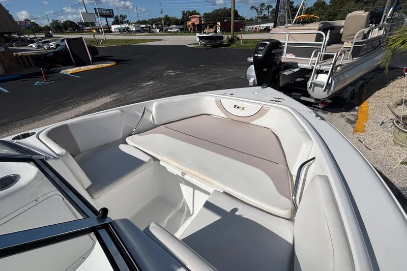 Slide: The Image of 2013 Sea Hunt Escape 188 boat interior with seating, parked outdoors. - 20