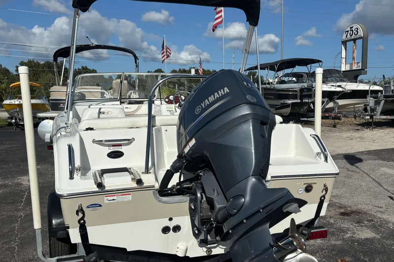 Slide: The Image of 2013 Sea Hunt Escape 188 boat with Yamaha outboard motor, parked outdoors. - 4