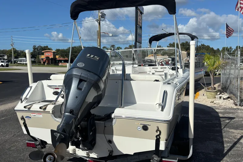 Slide: The Image of 2013 Sea Hunt Escape 188 boat with 115 horsepower engine, parked outdoors. - 5