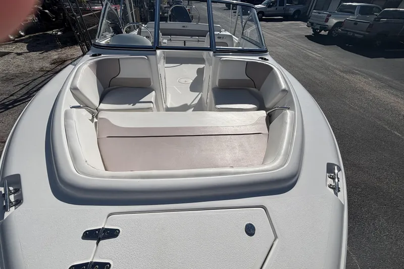 Slide: The Image of 2013 Sea Hunt Escape 188 boat interior with white seating and windshield. - 6
