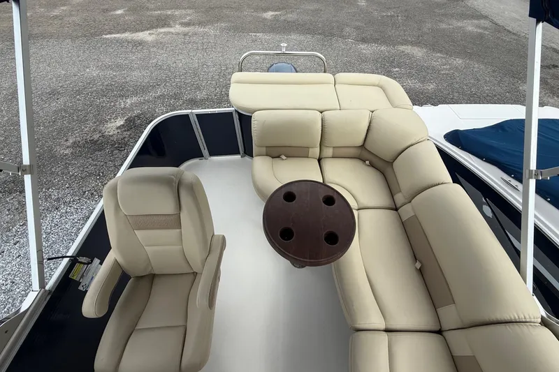 Slide: The Image of 2018 SouthWind V23 L boat interior with beige seating and round table. - 11