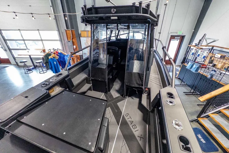 Slide: The Image of 2024 StabiX 240UCC boat interior in showroom, featuring sleek design and modern amenities. - 11