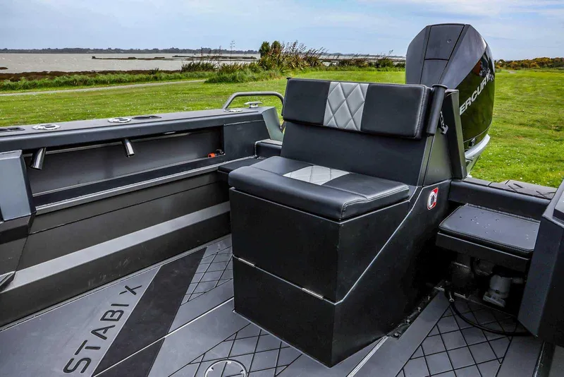 Slide: The Image of 2024 StabiX 240UCC boat interior with cushioned seating and modern design. - 12