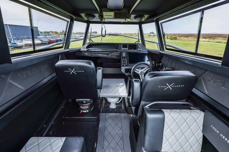 Slide: The Image of Interior of 2024 StabiX 240UCC boat with modern seating and control panel. - 16