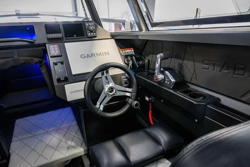 Slide: The Image of Interior of 2024 StabiX 240UCC boat with Garmin navigation system and modern controls. - 17